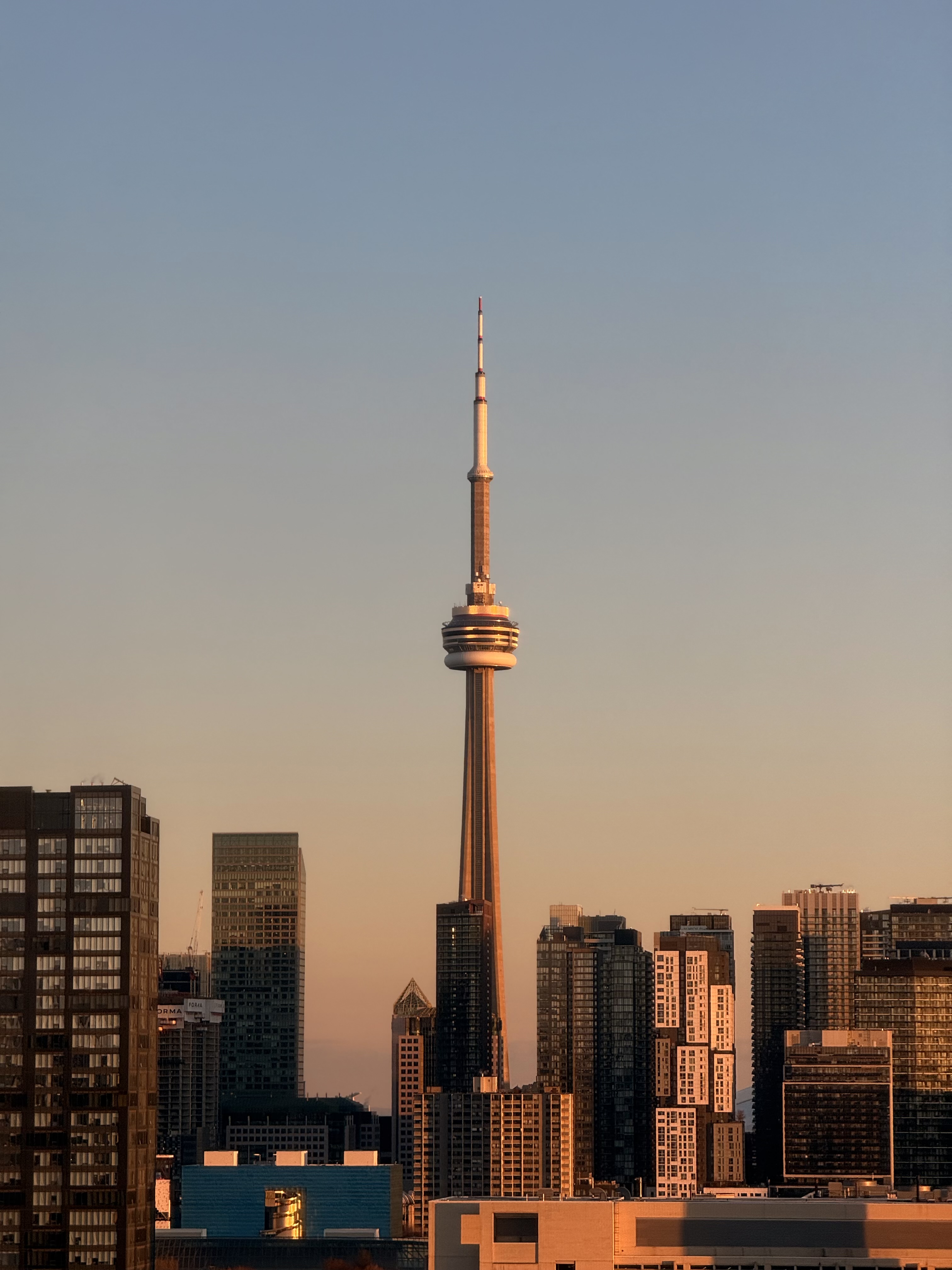 The CN Tower over the downtown Toronto skyline at golden hour